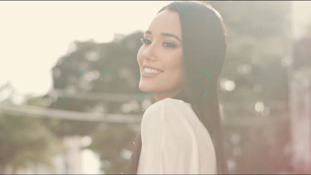 Mujer sonriendo en un atardecer, destello de luz